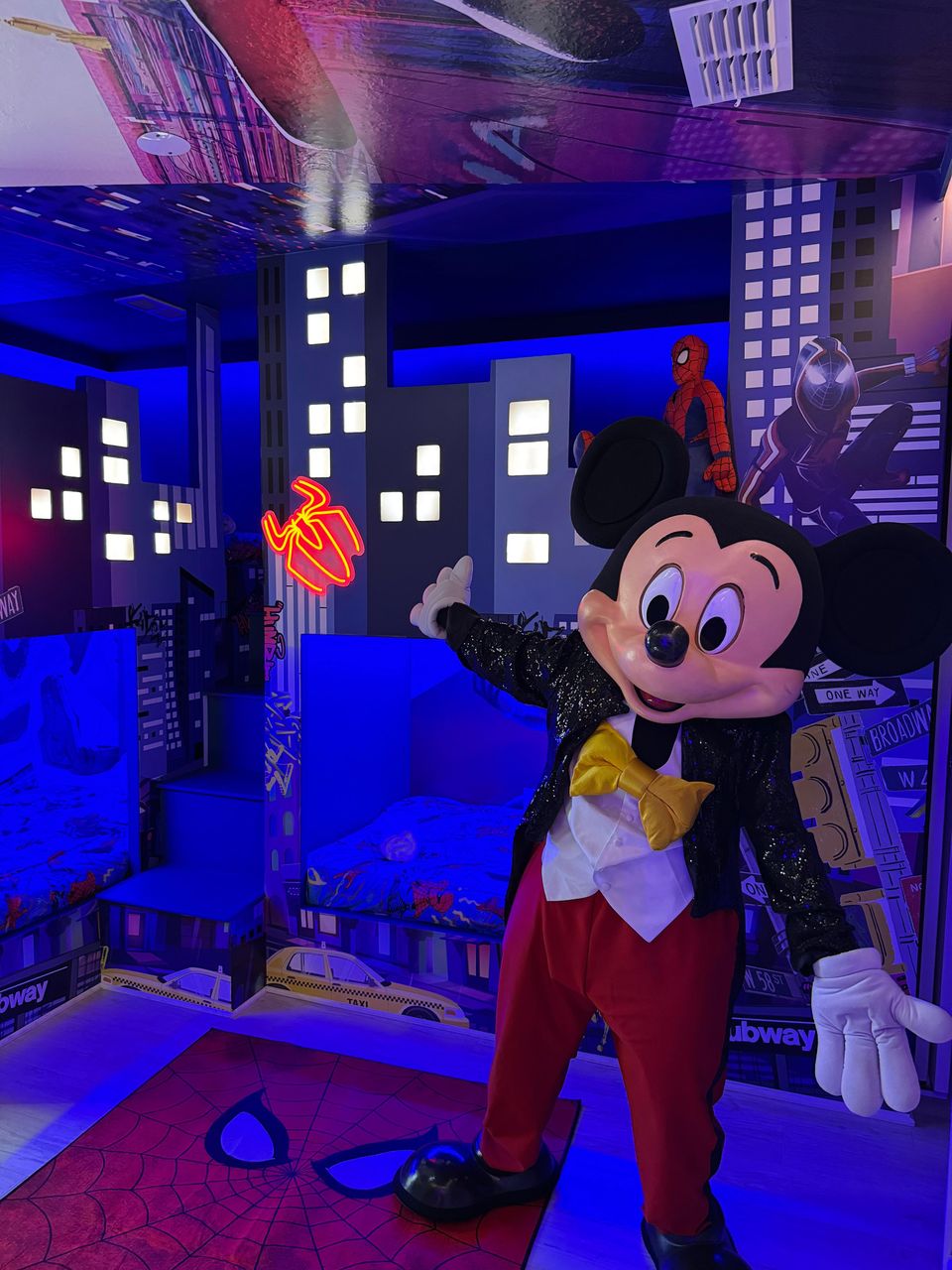 Superhero-themed kids' room with cityscape beds & neon fun!