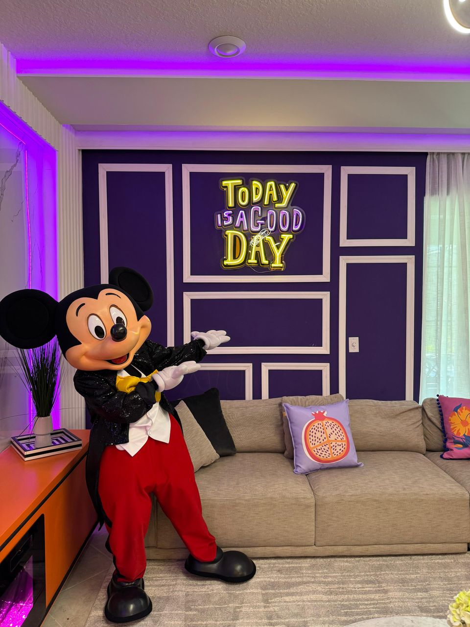 Bright living space with neon charm, cozy seating & magic fun!