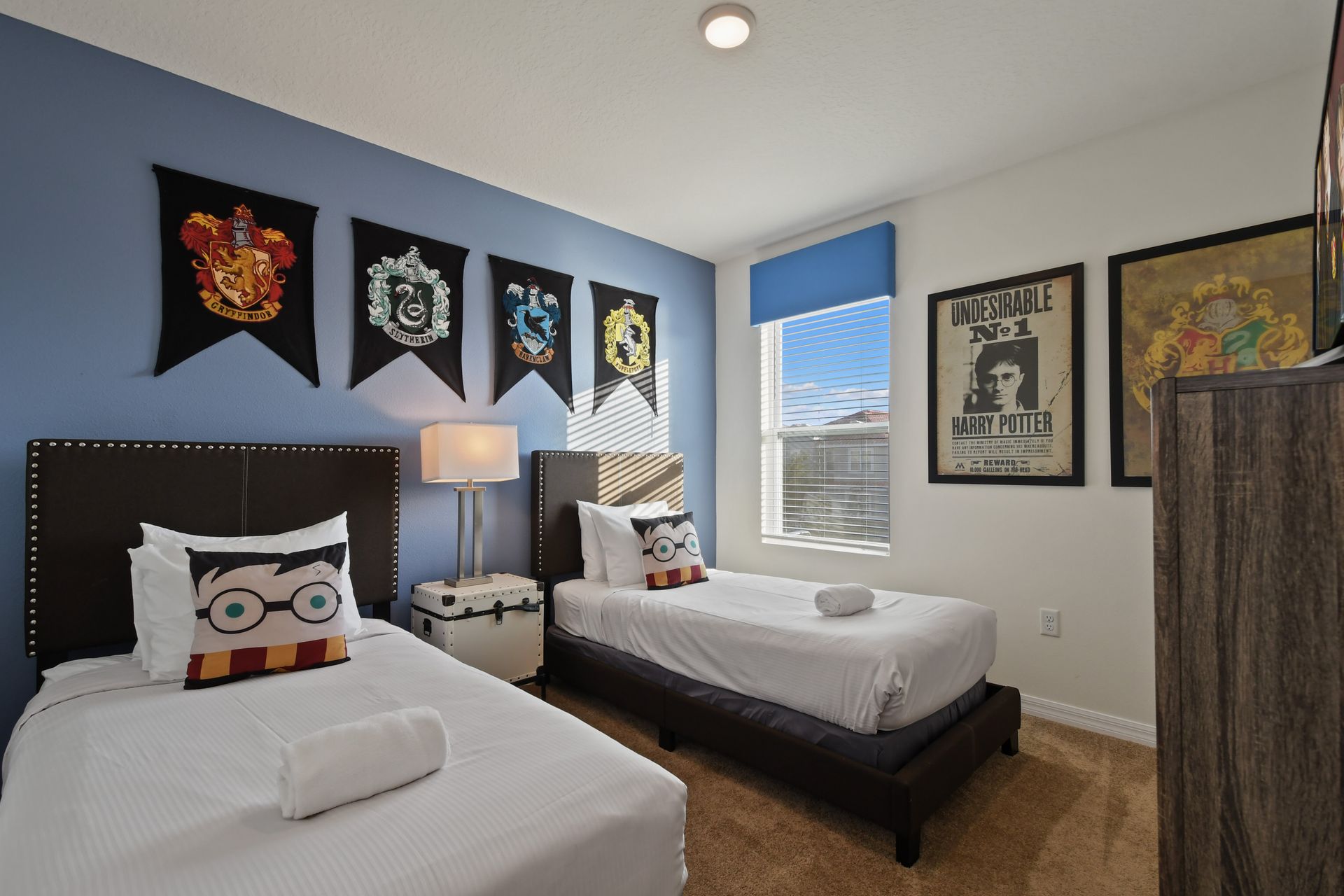 Charming twin bedroom with a magical wizarding theme and cozy character pillows.