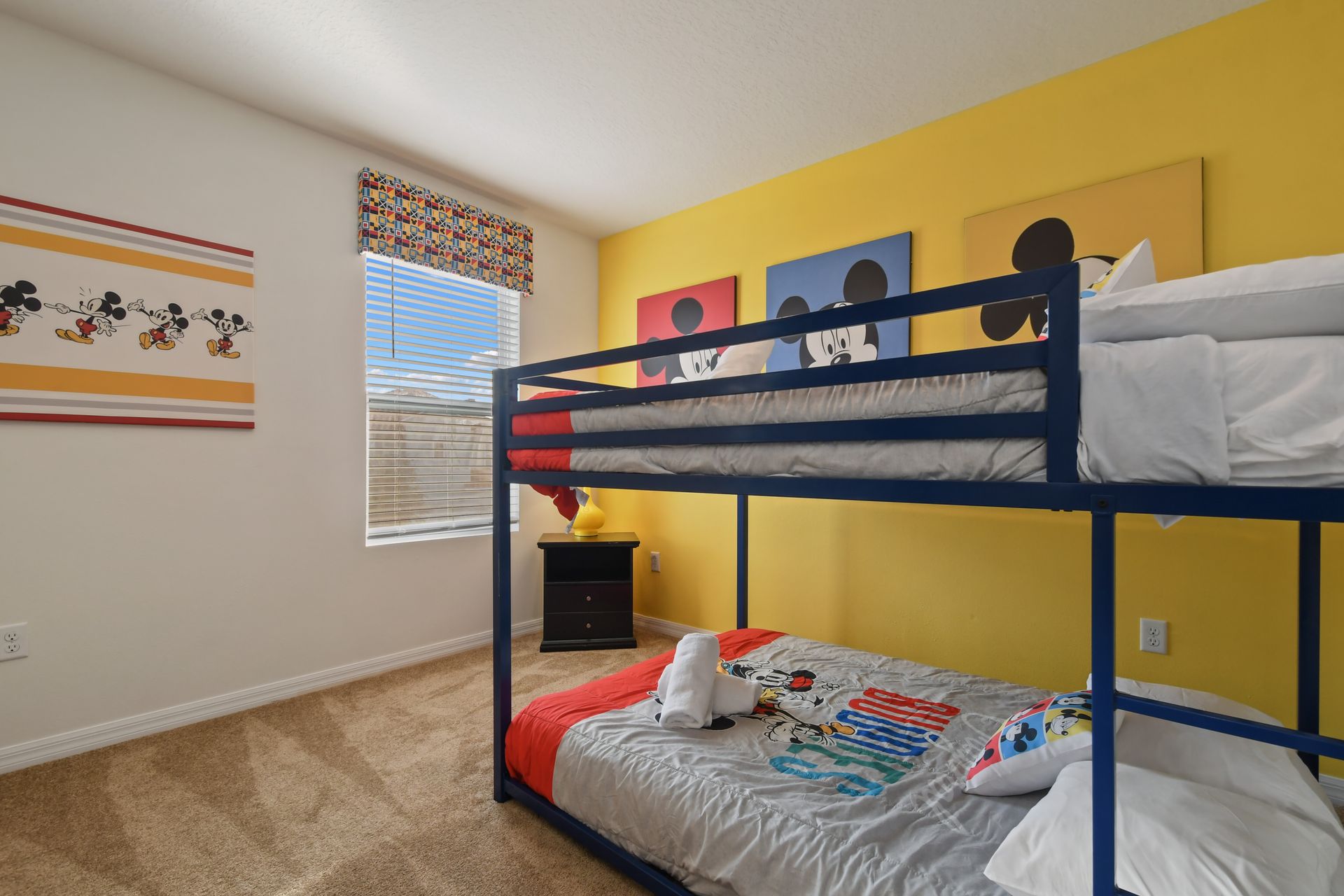 Bright and cheerful bunk room with playful character decor, perfect for kids' fun.