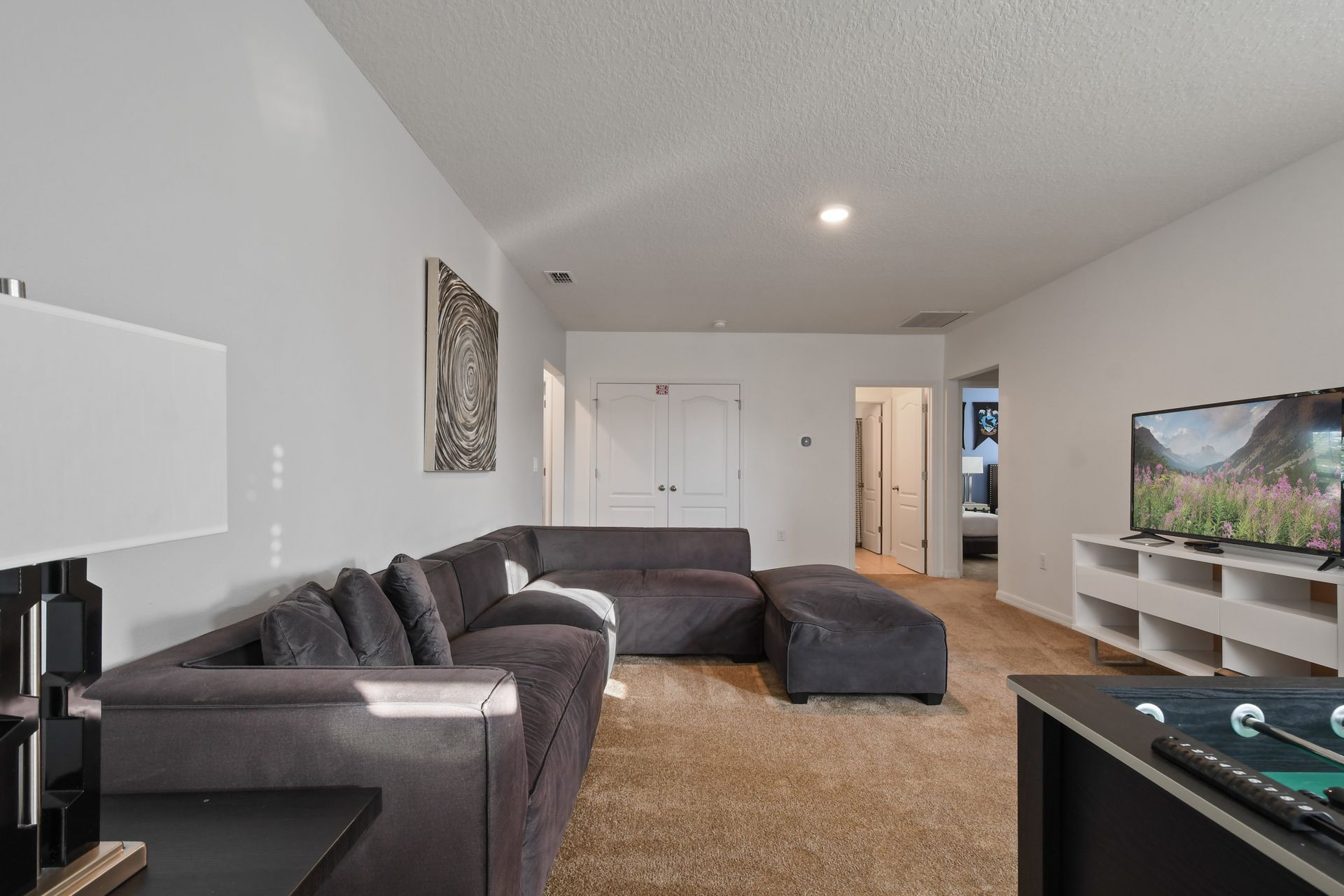 Relax and unwind in the loft with foosball, a plush sectional, and smart TV.