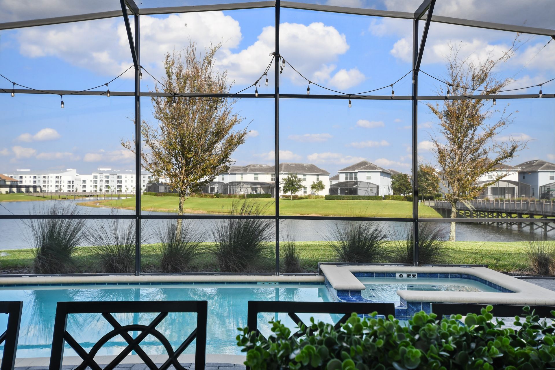 Soak up the sun in this private screened-in pool and spa with serene lake views!