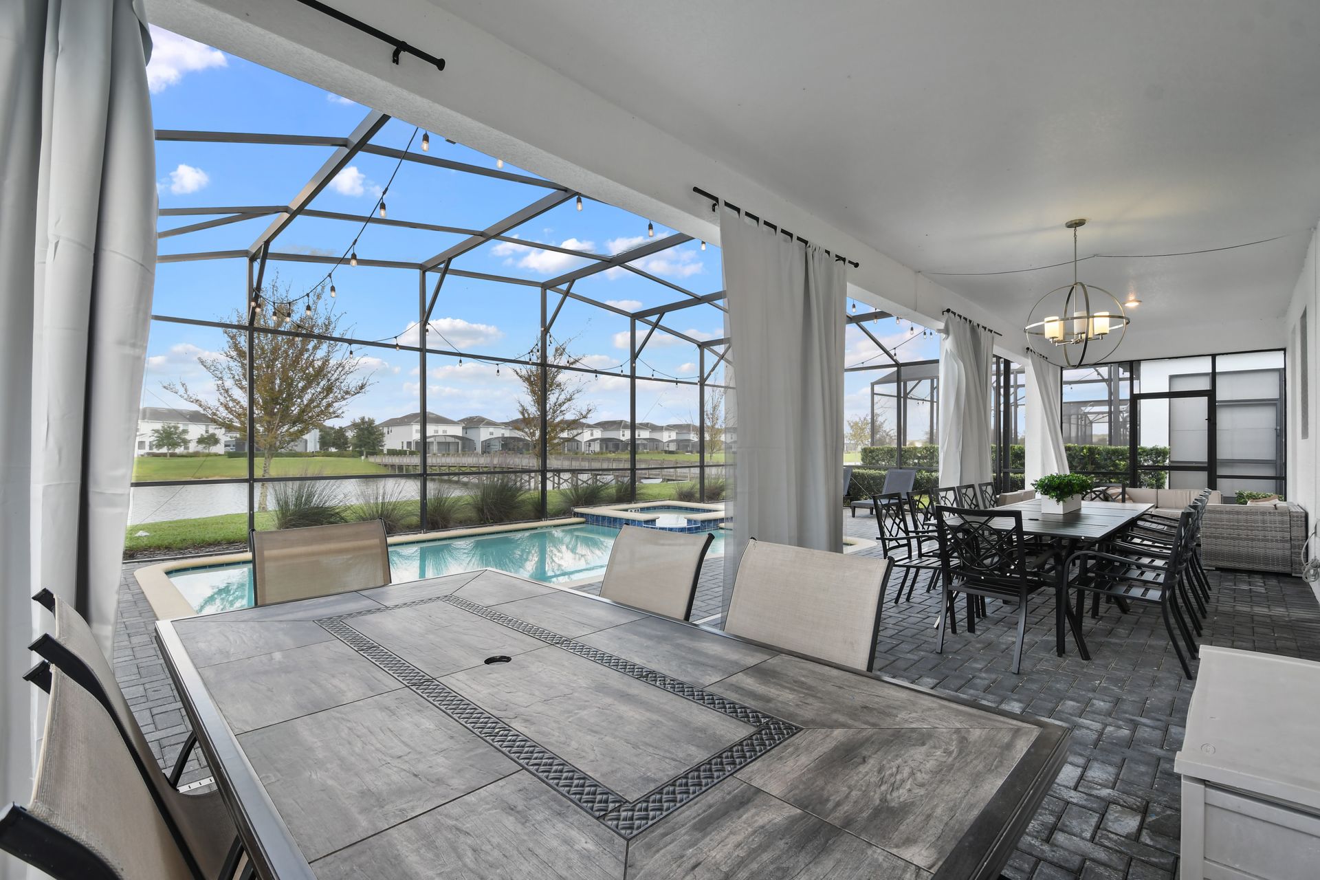 Host unforgettable gatherings in this spacious covered patio with pool and lake views!