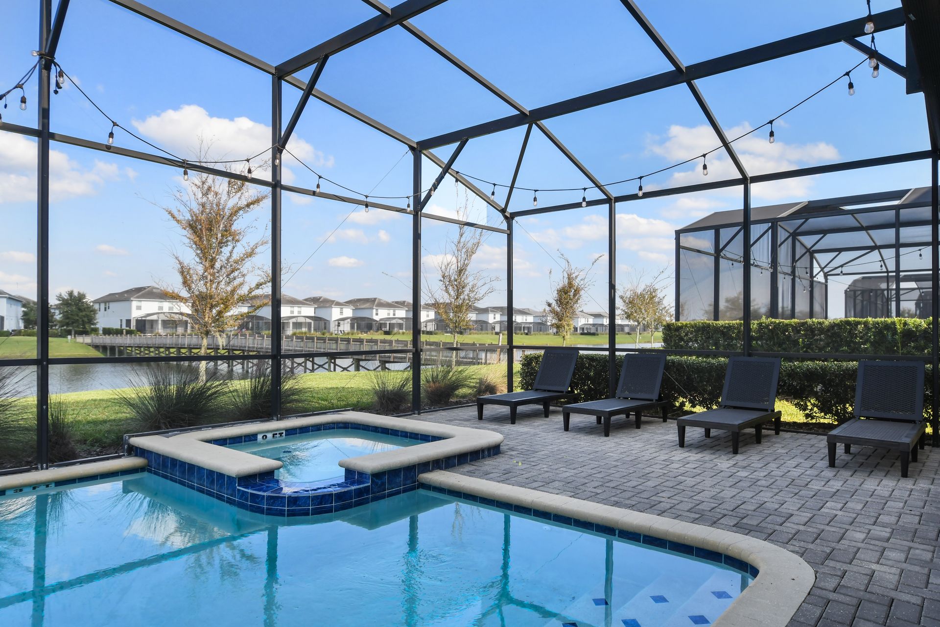 Soak up the sun in this private screened-in pool and spa with serene lake views!