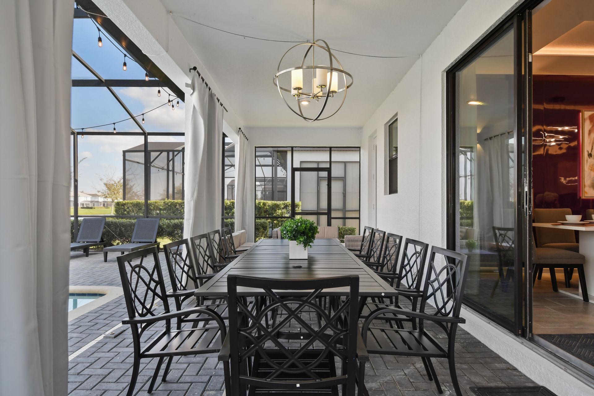 Gather under the lights in this stylish covered patio with seating for the whole crew!