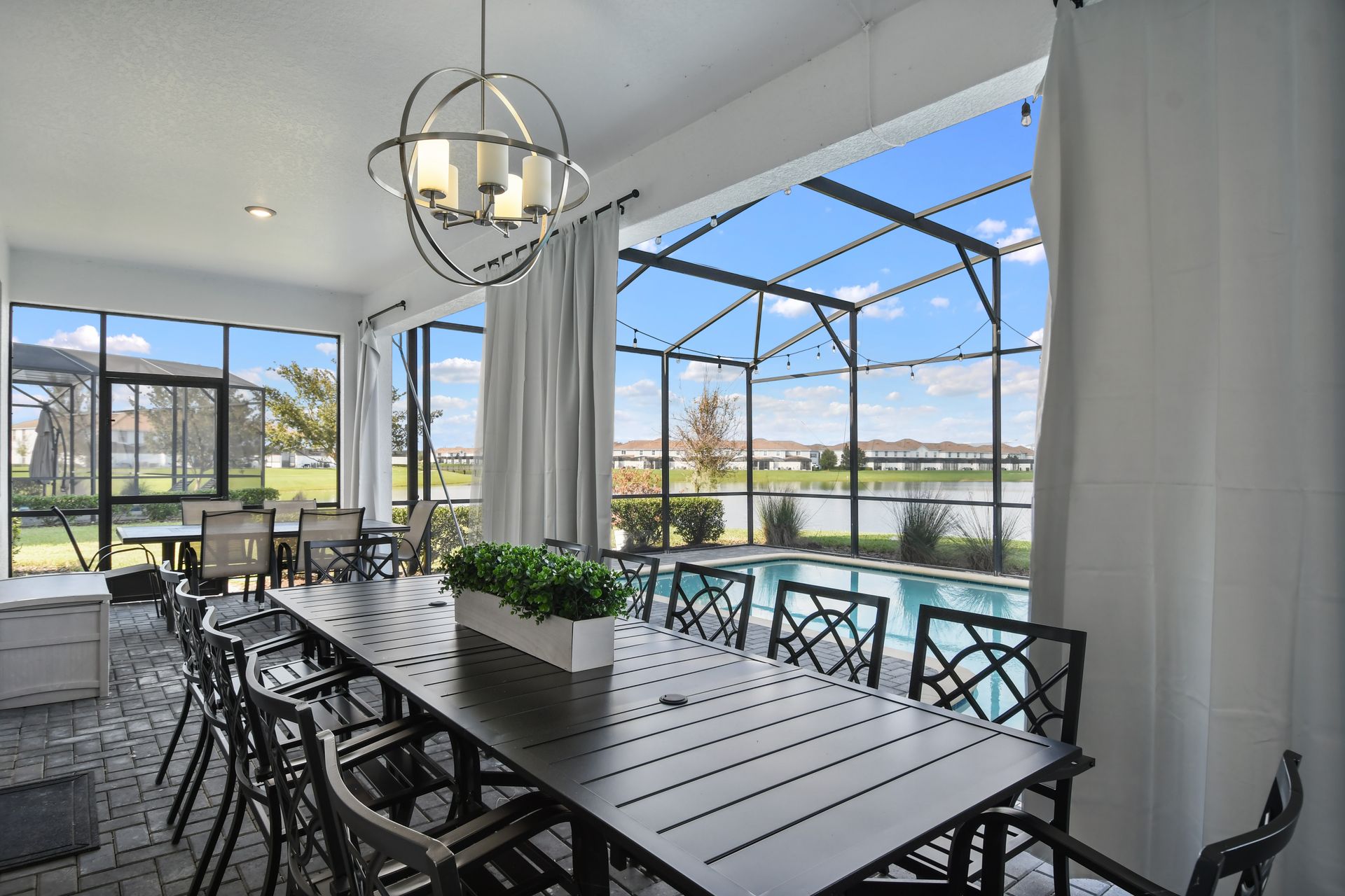 Dine al fresco in this elegant screened patio with pool views and lakeside charm!