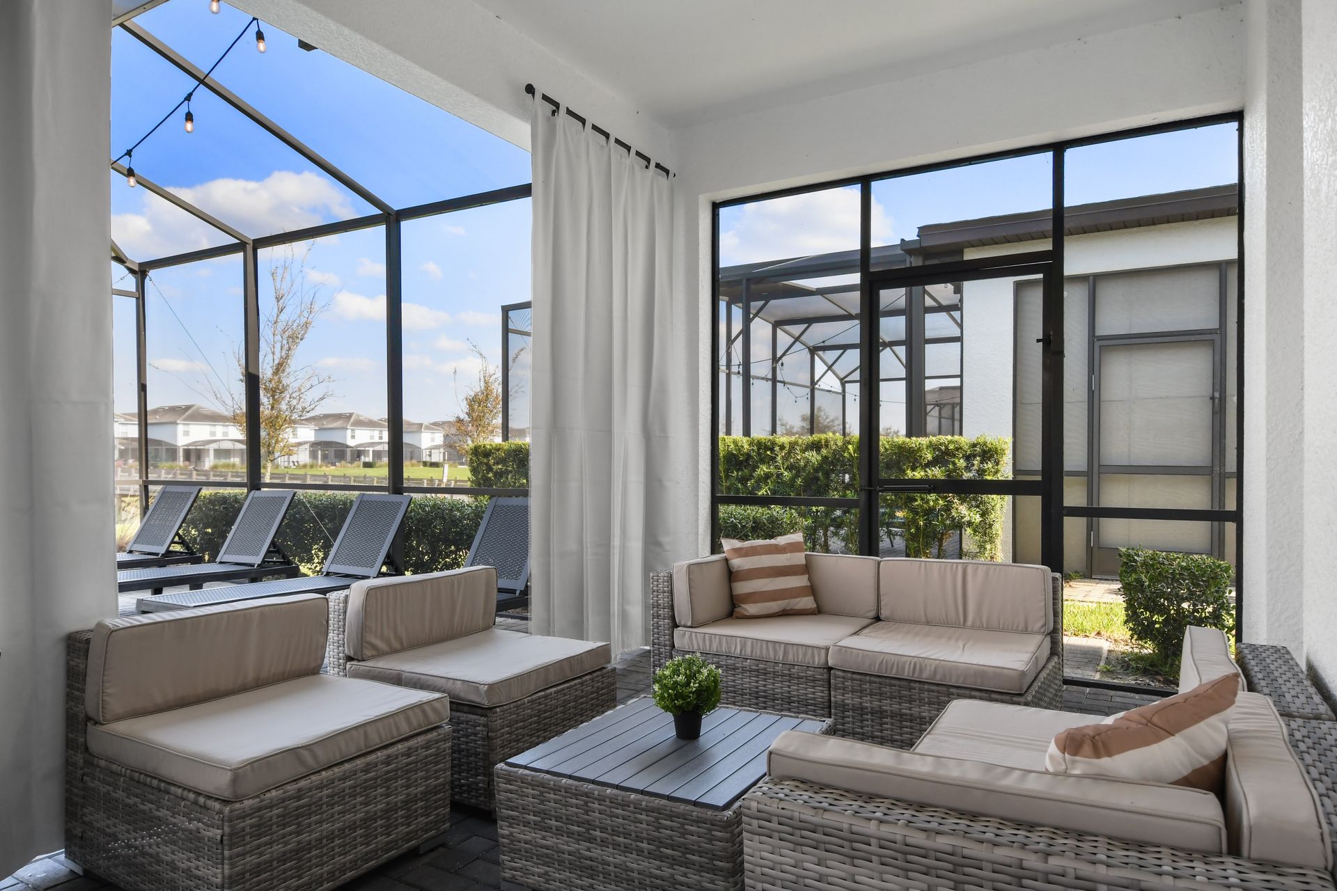 Kick back in this cozy outdoor lounge with plush seating and tranquil screened views!