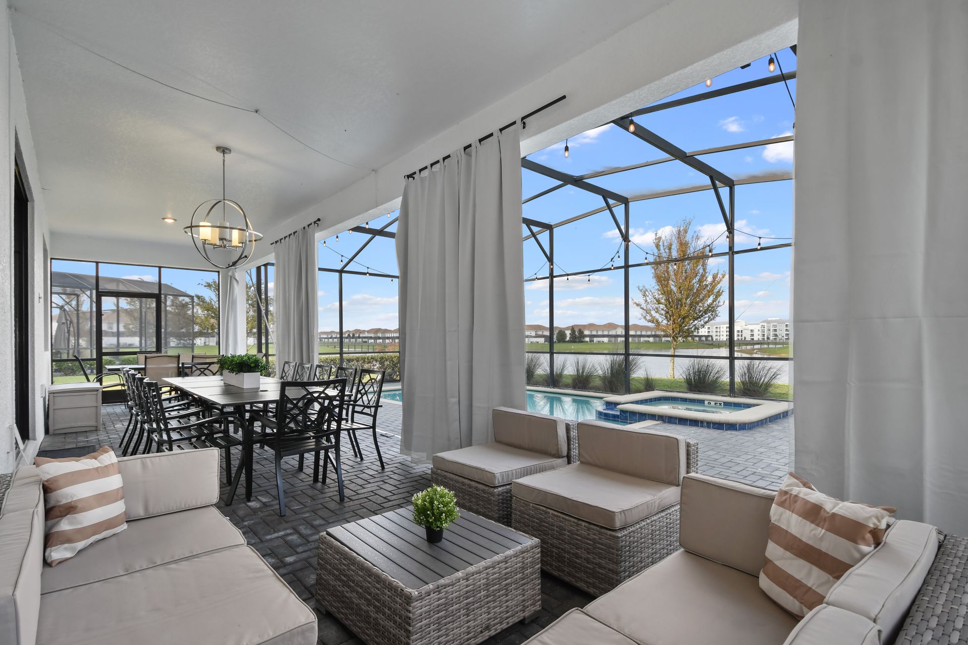 Dine al fresco in this elegant screened patio with pool views and lakeside charm!
