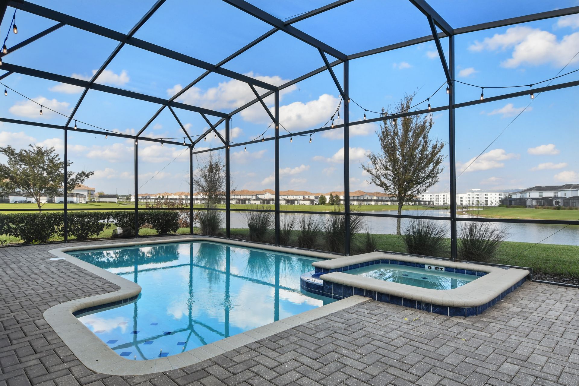 Soak up the sun in this private screened-in pool and spa with serene lake views!