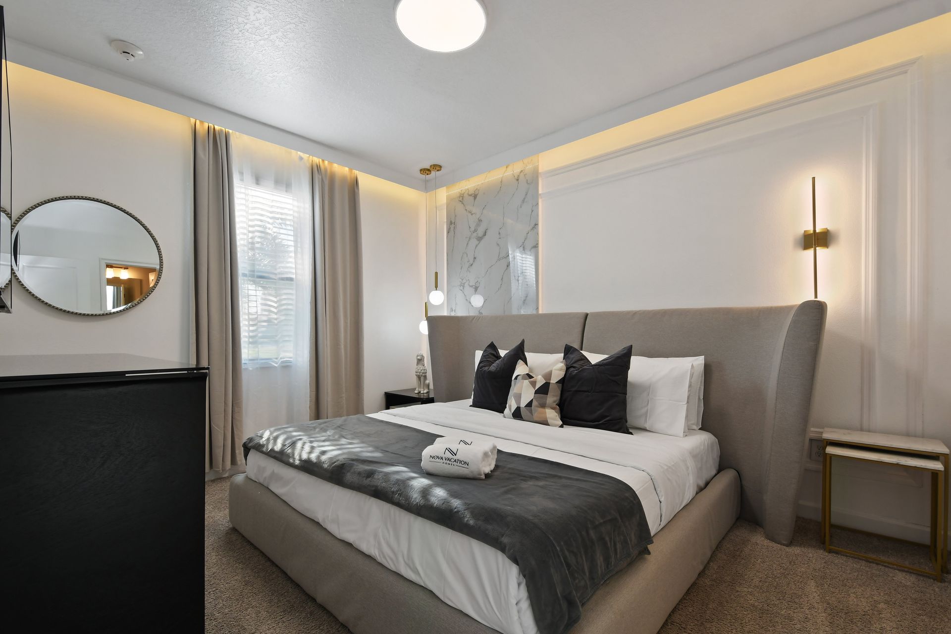 Relax in this serene modern suite featuring luxe textures, soft lighting, and style!