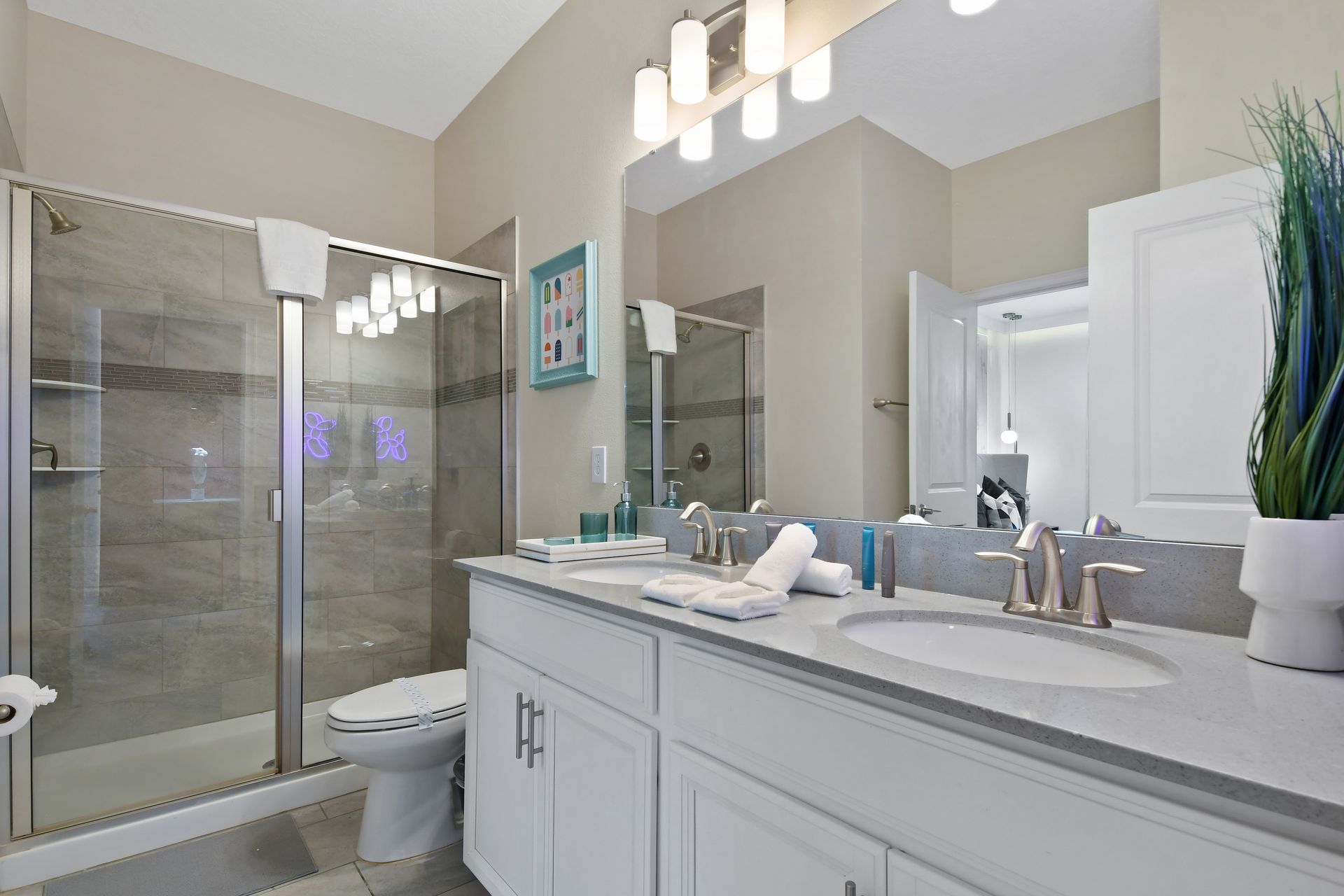 Refresh in this sleek double-vanity bathroom with a spacious glass walk-in shower!