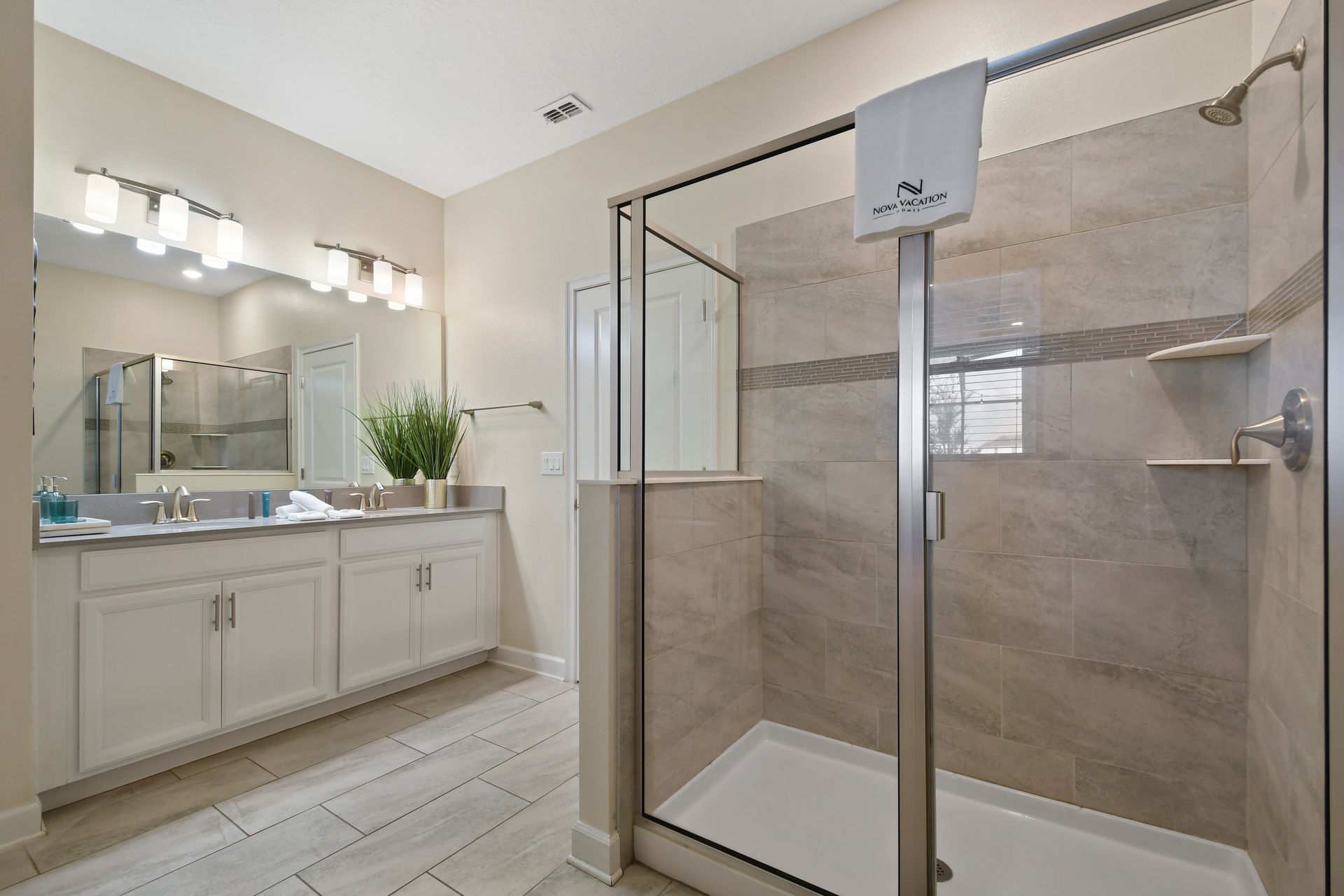 Refresh in this sleek double-vanity bathroom with a spacious glass walk-in shower!