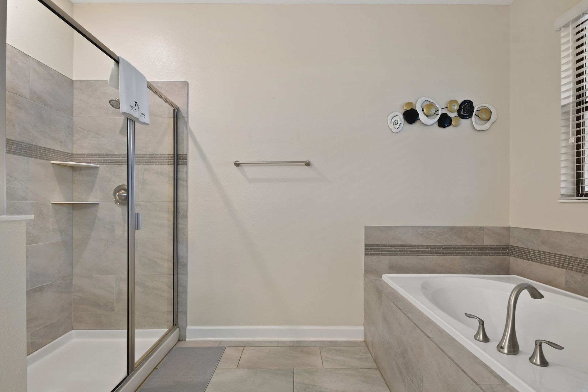 Unwind in this spa-inspired bathroom with a soaking tub and sleek glass shower!