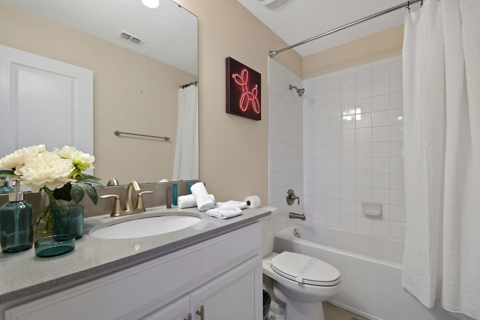Bright, stylish bathroom with modern fixtures and a relaxing bathtub shower.