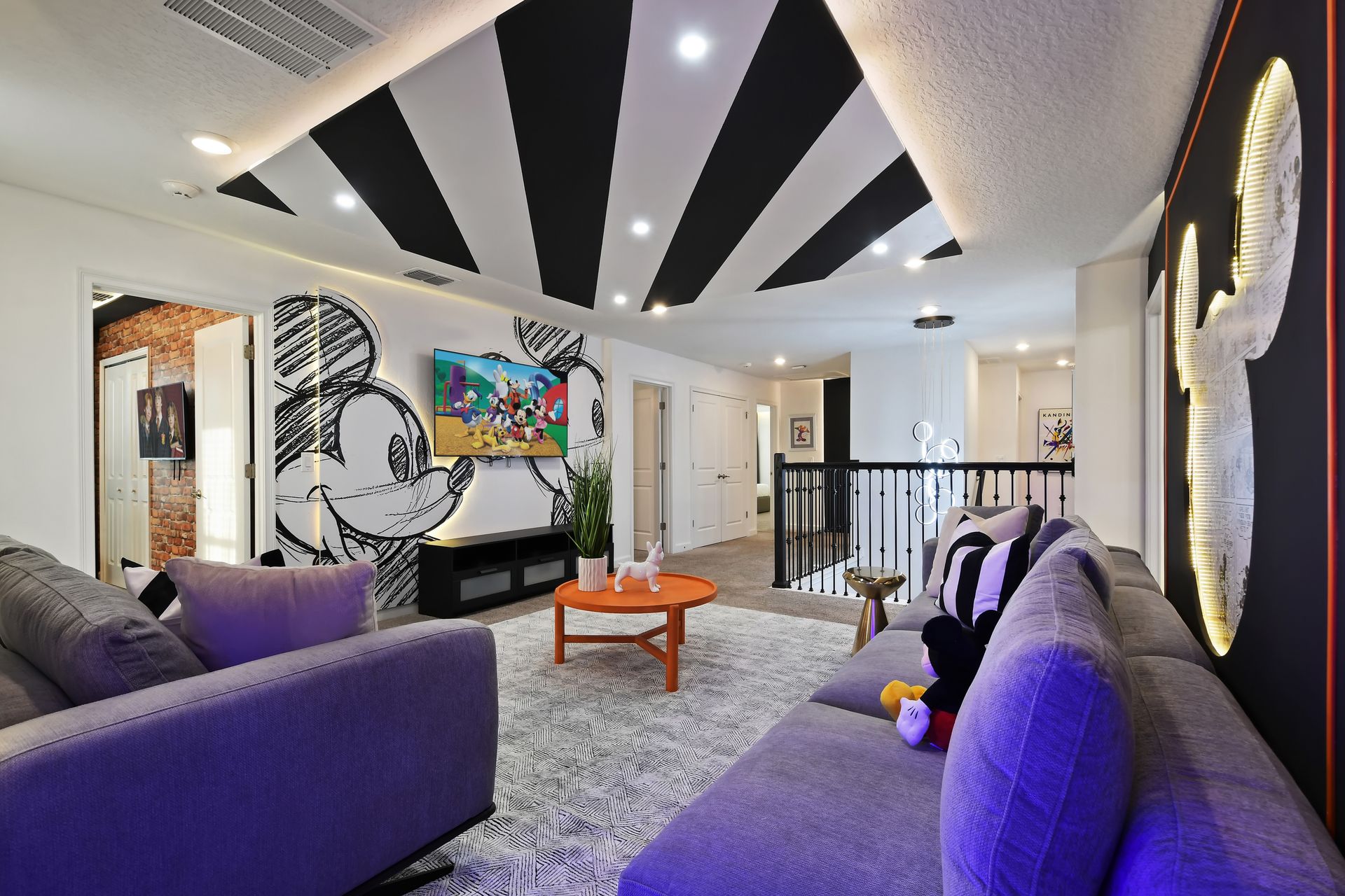 Get cozy in this playful Mickey-themed lounge, perfect for movie nights and magic!
