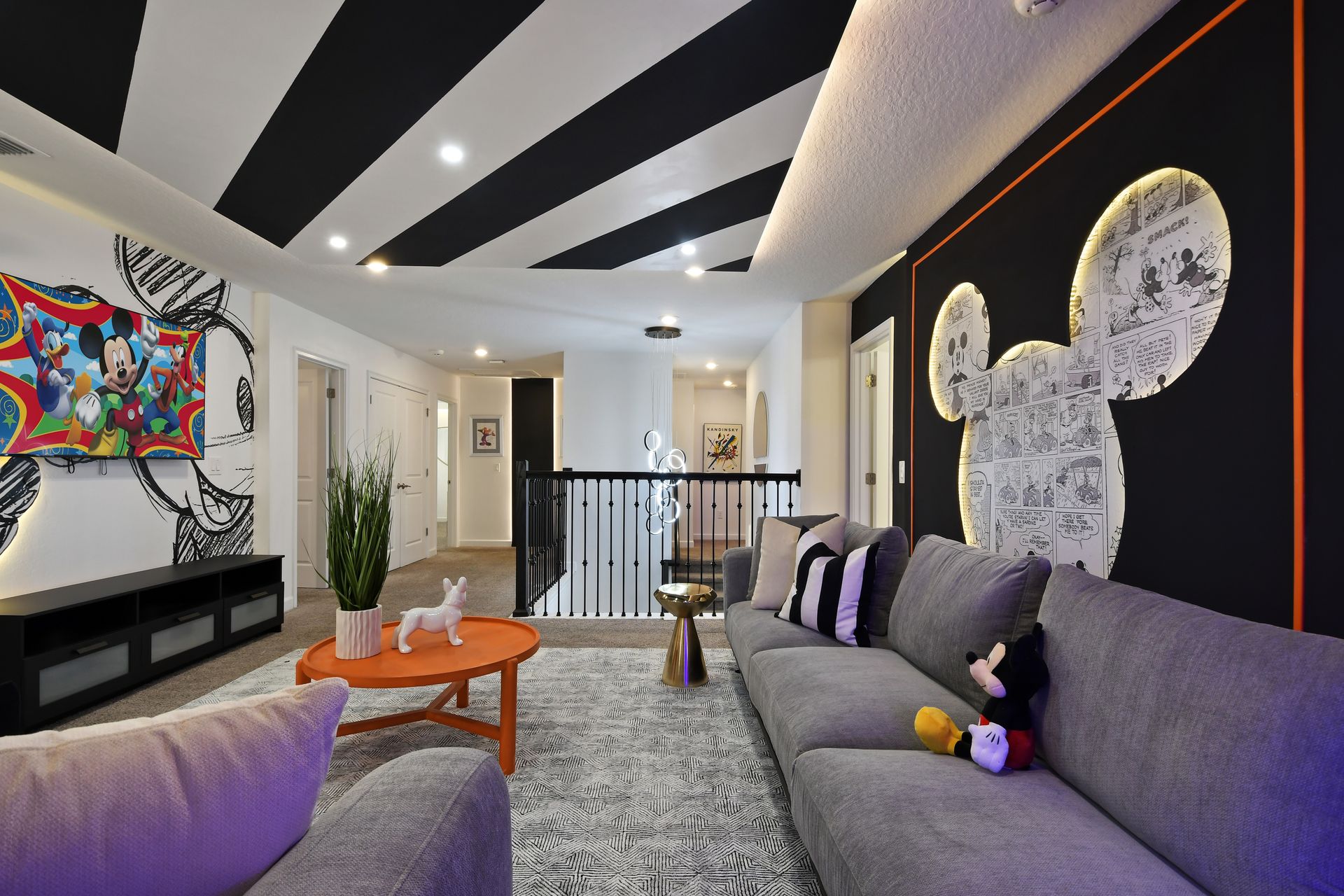 Get cozy in this playful Mickey-themed lounge, perfect for movie nights and magic!