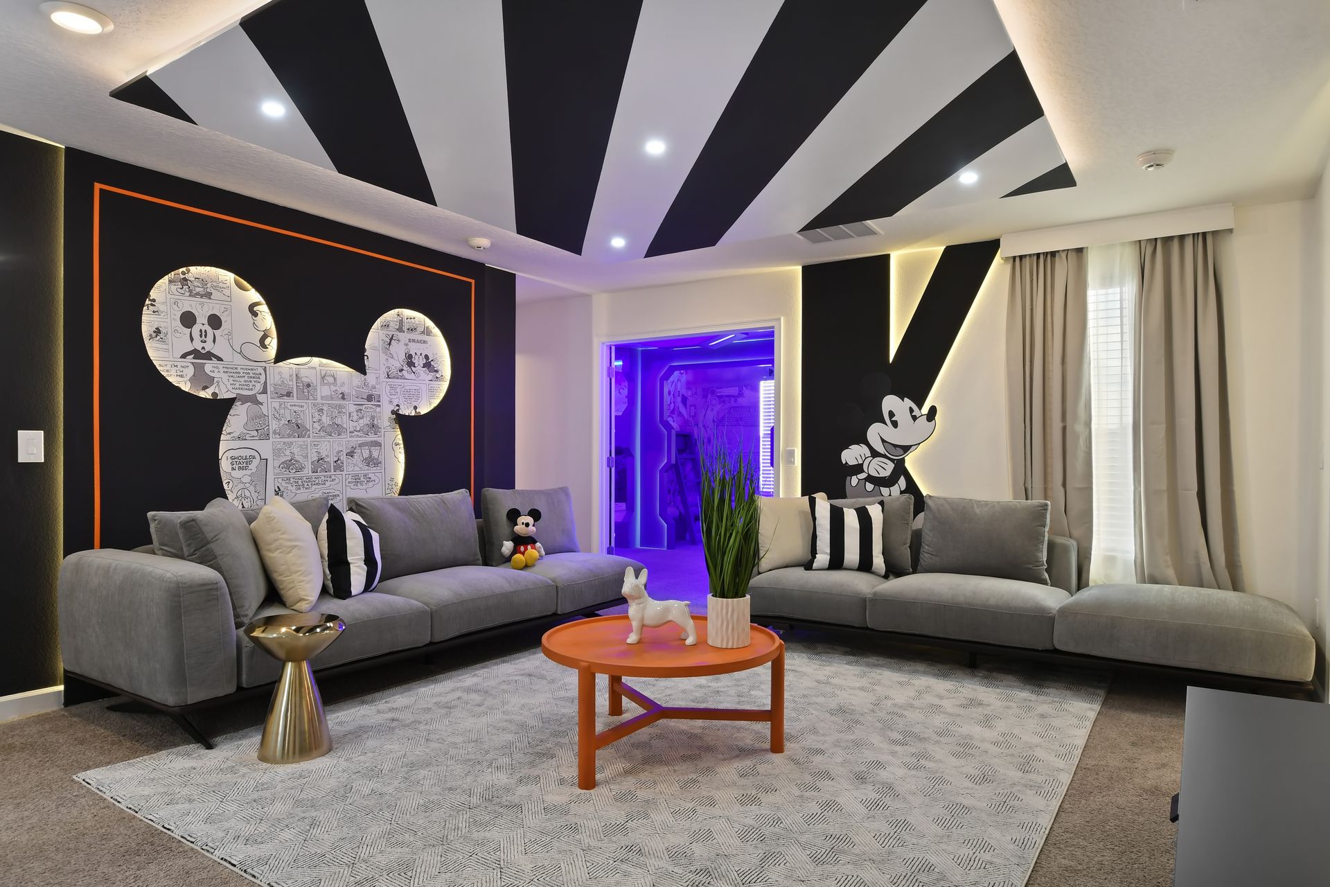 Get cozy in this playful Mickey-themed lounge, perfect for movie nights and magic!