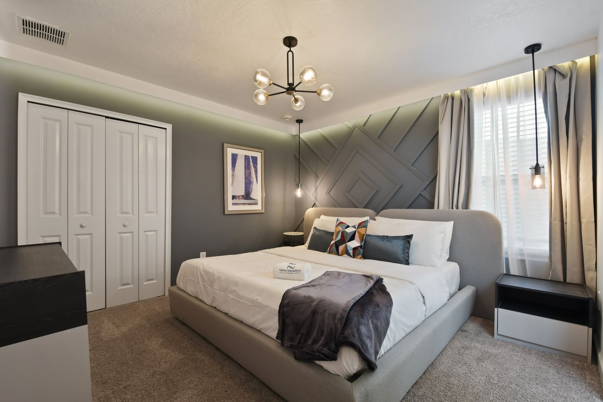 Drift off in this moody-modern retreat with geometric walls and cozy king bed!