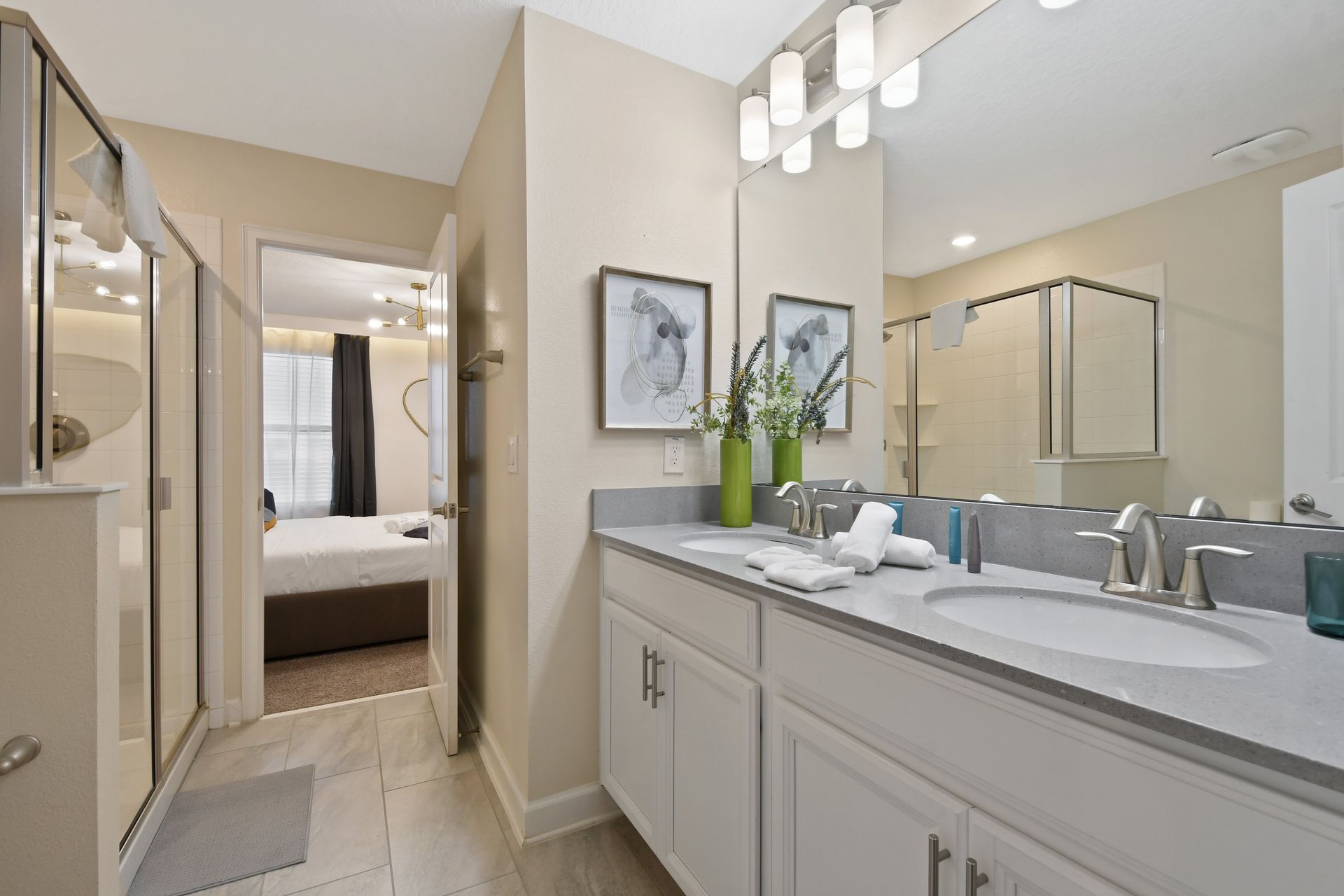 Modern en-suite bathroom with double vanity and spacious glass walk-in shower.