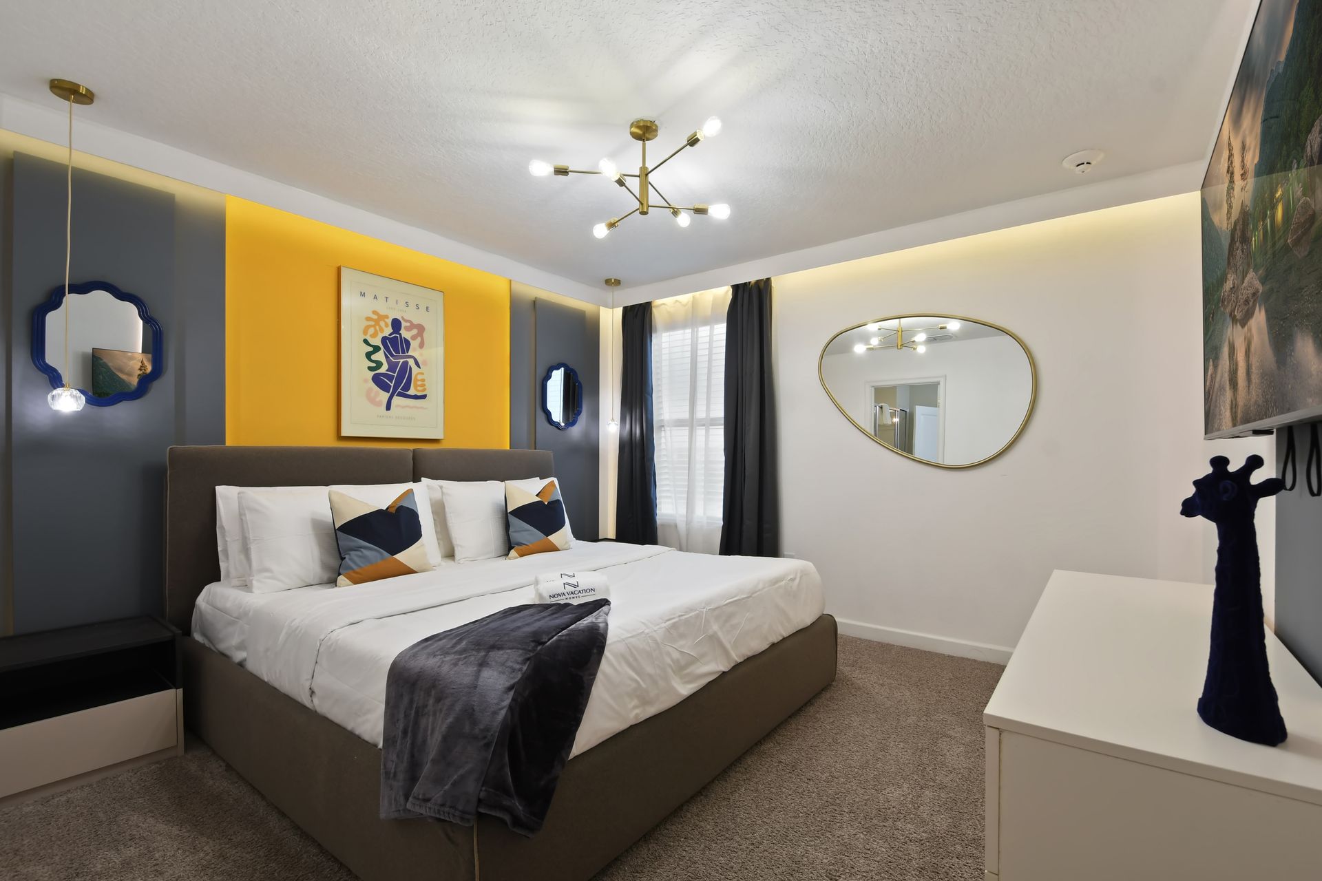 Brighten your stay in this modern room with bold colors, fun art, and cozy vibes!