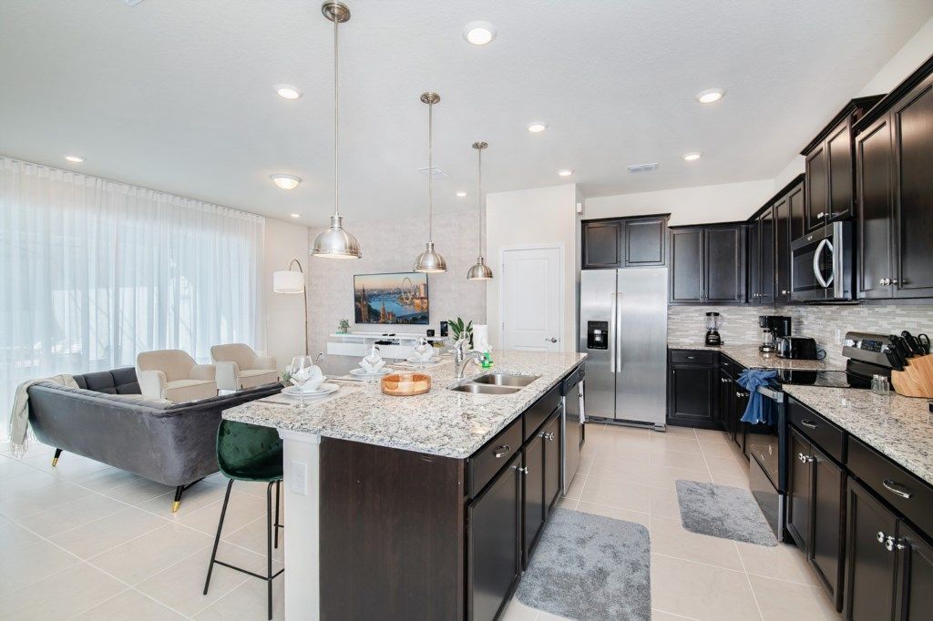 Spacious open kitchen and living area with upscale finishes and natural light.