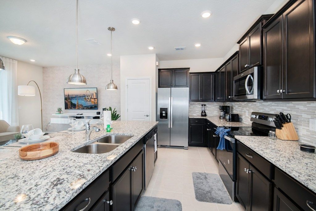 Fully equipped chef’s kitchen with granite countertops and stainless appliances.