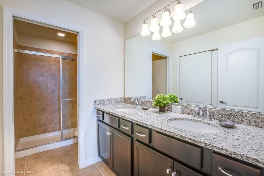 Elegant double vanity bath with walk-in shower, designed for comfort and ease.