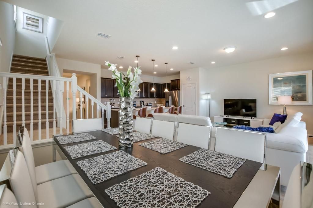 Open-concept dining, kitchen, and living space with stylish decor and comfy seating.