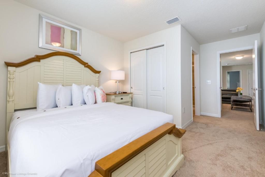 Inviting queen bedroom with elegant wood accents, ensuite bath, and soft lighting.