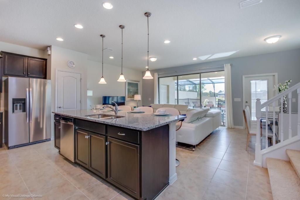 Spacious kitchen and living area with granite island, stainless appliances, and views.