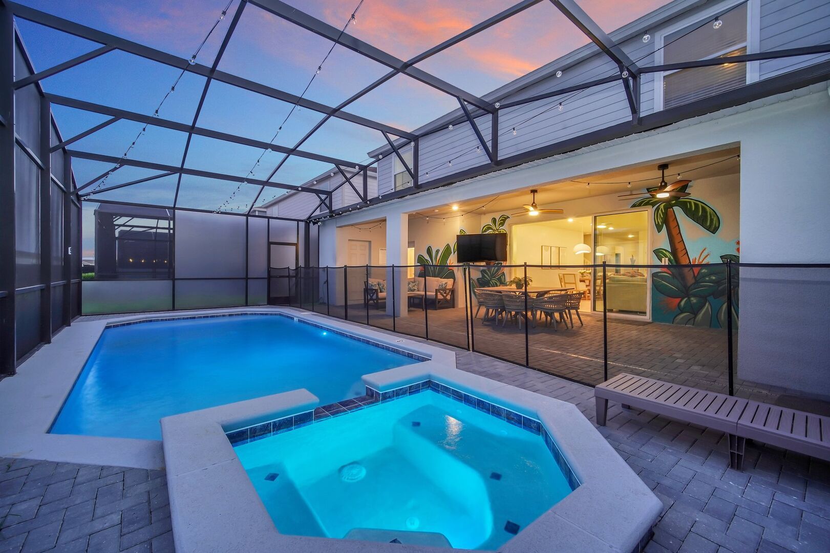 Evening swim in a heated pool with ambient lighting and outdoor seating.