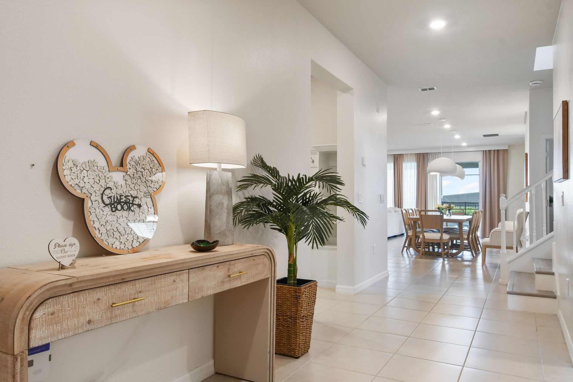 Cozy entryway with rustic table, Mickey guest book, and lamp.
