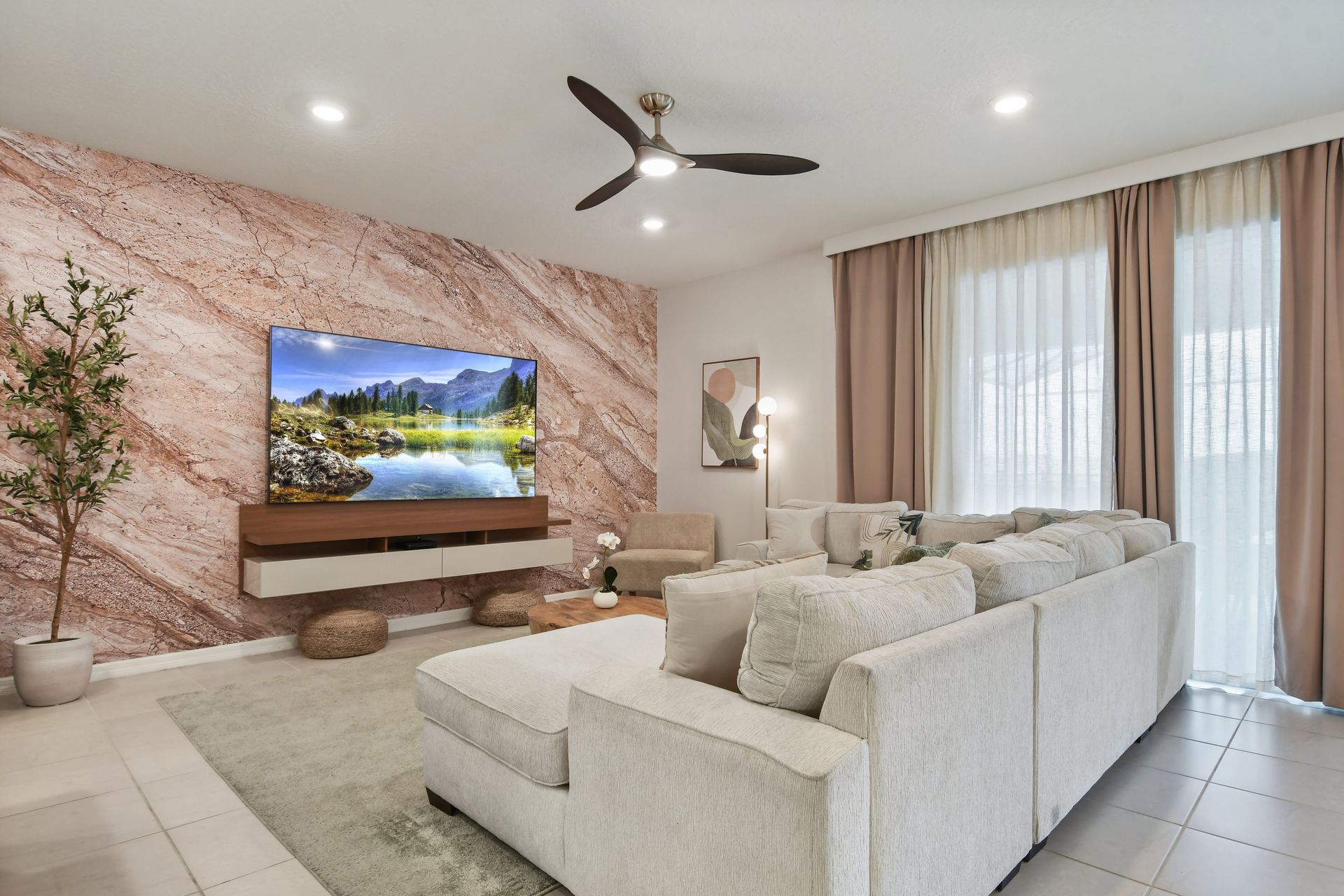 Relax in style with this plush sectional, nature-inspired decor, and modern TV setup!