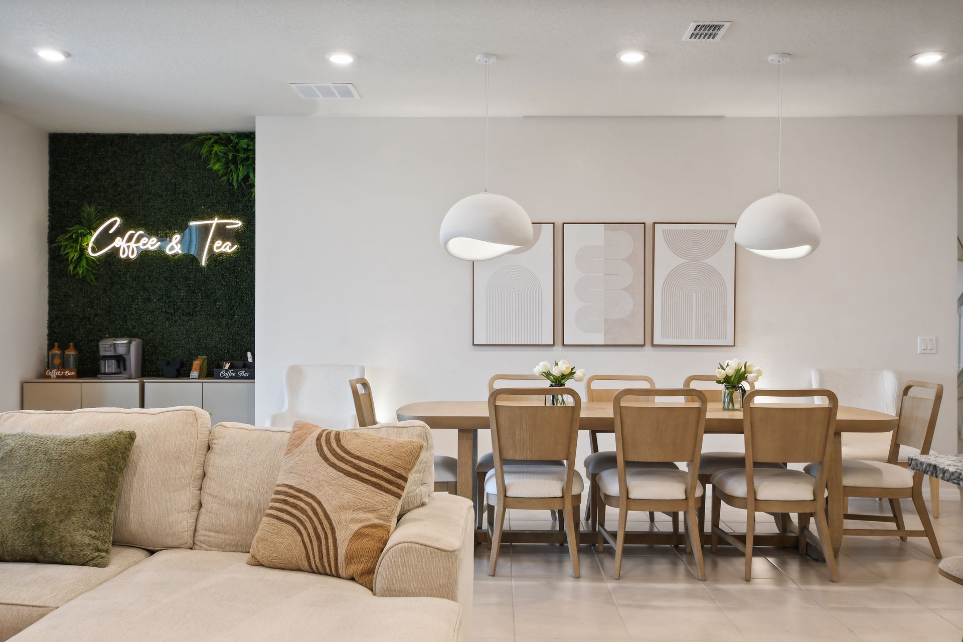 Stylish dining area with seating for 8, modern decor, and a charming coffee nook!