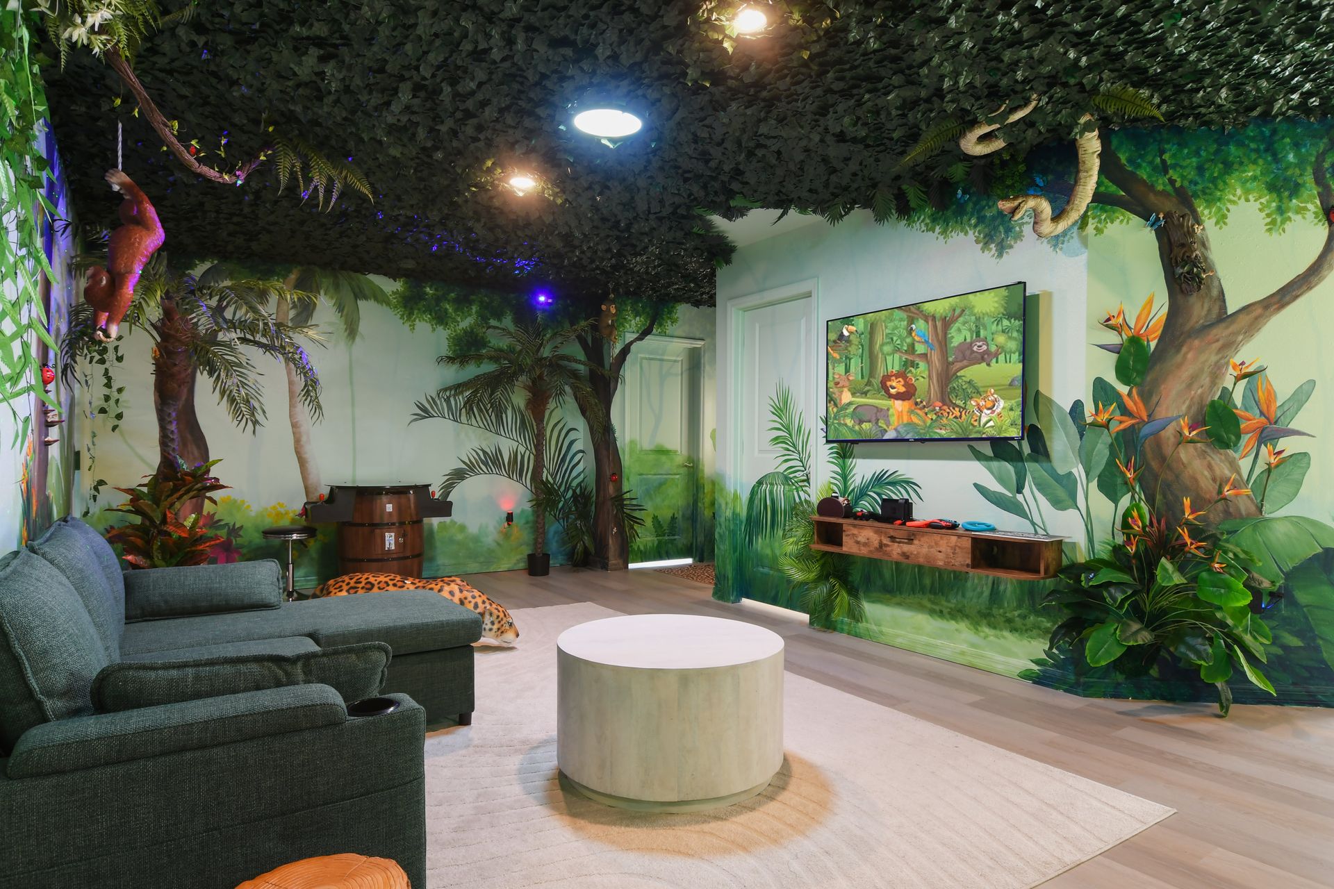Immerse yourself in this jungle-themed entertainment room, perfect for family fun!