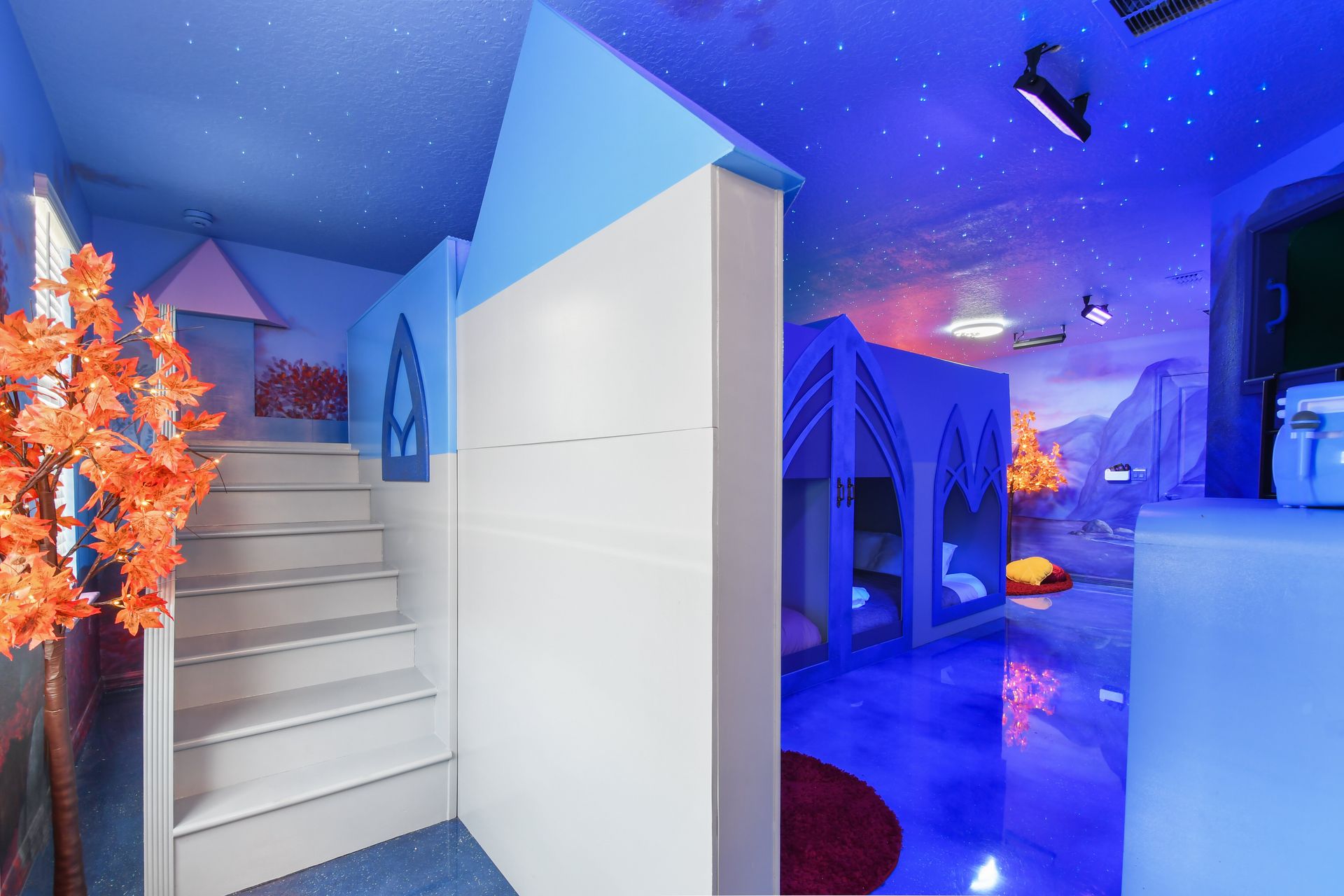 Whimsical ice castle bunk room with glowing trees and starry skies!