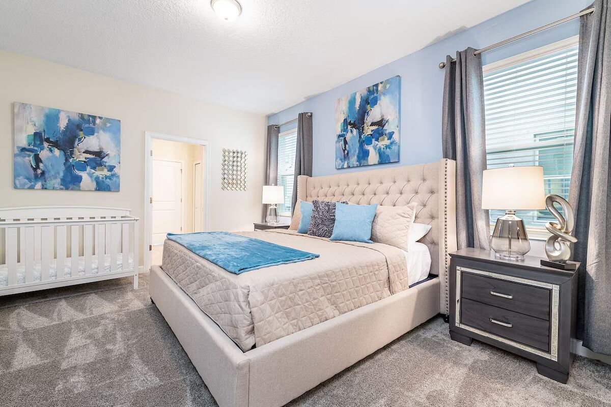 Serene master suite with king bed, elegant decor, and a cozy crib for baby!
