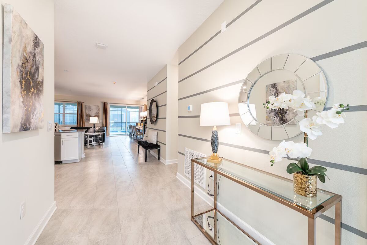 Elegant entryway with modern décor, sleek tile floors, and open-concept living ahead.