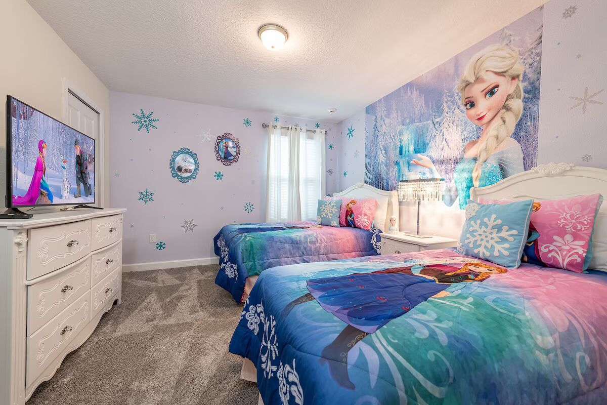 Magical Frozen-themed room with twin beds, snowflake decor, and a smart TV!
