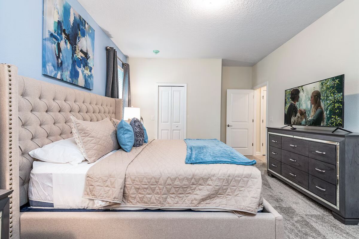 Serene master suite with king bed, elegant decor, and a cozy crib for baby!