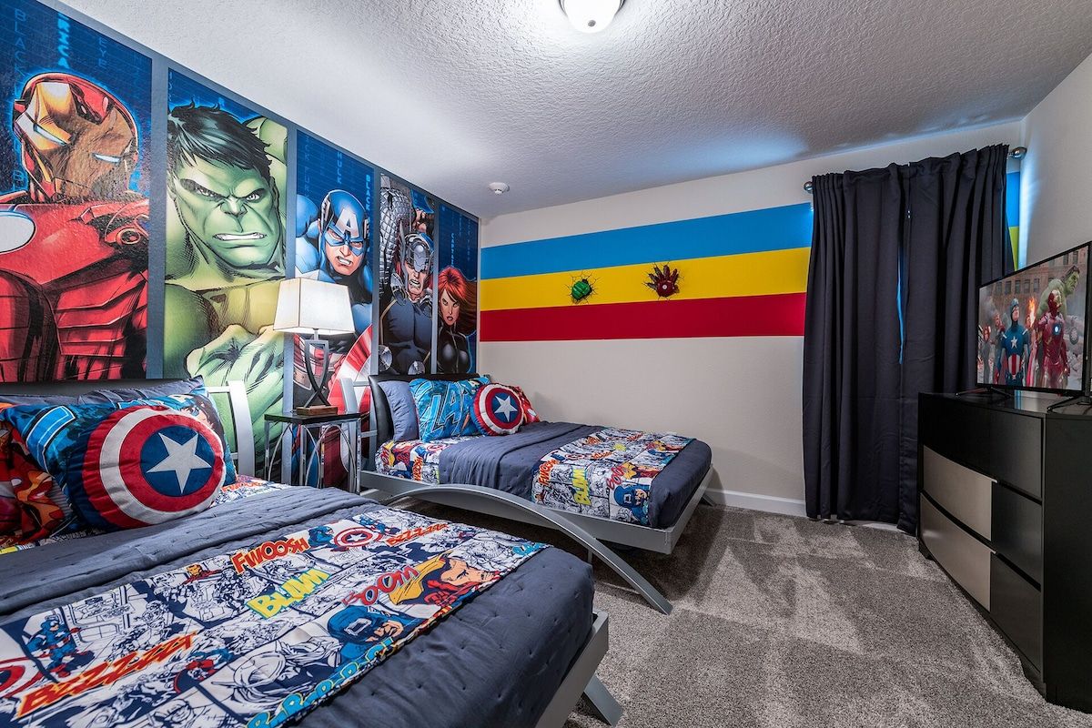 Action-packed hero room with twin beds, bold murals, and a wall-mounted TV!