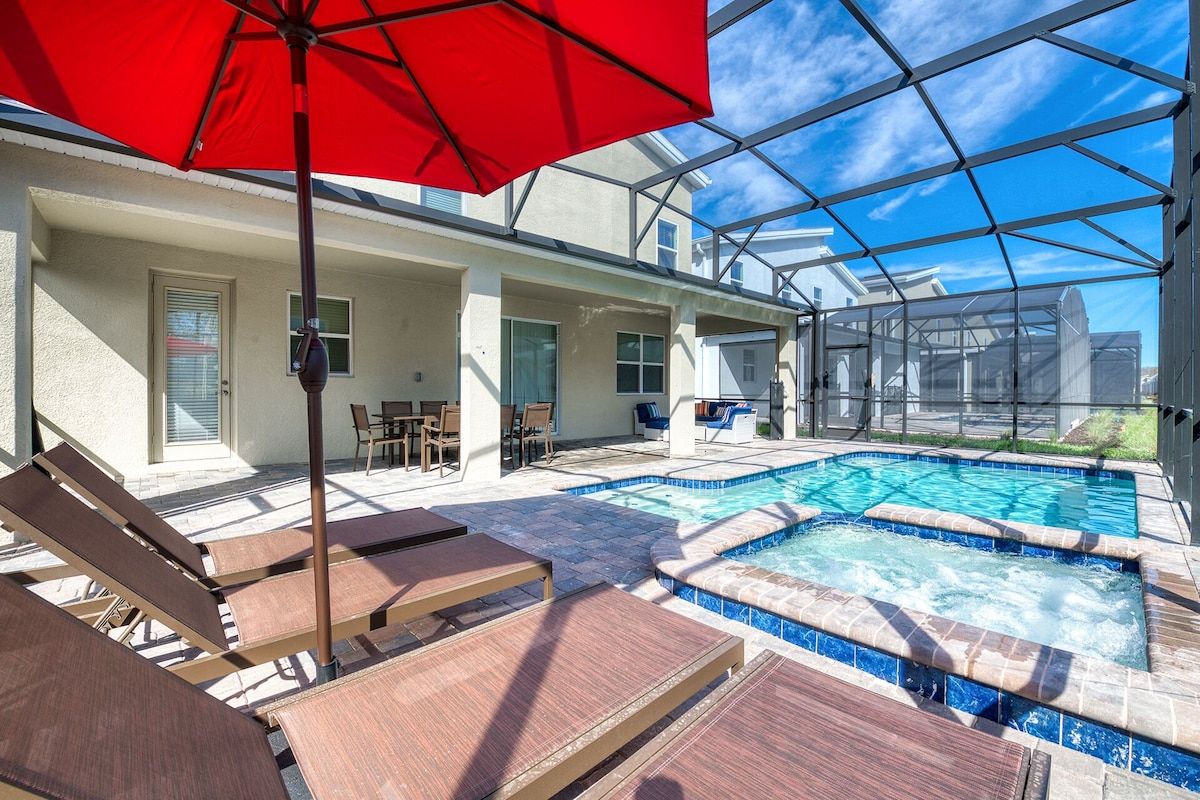 Relax in style with a sparkling pool, bubbling spa, loungers, and shaded patio.