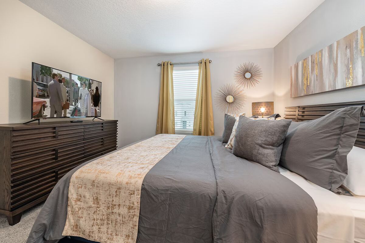 Cozy king suite with modern wood furniture, stylish decor, and a smart TV!