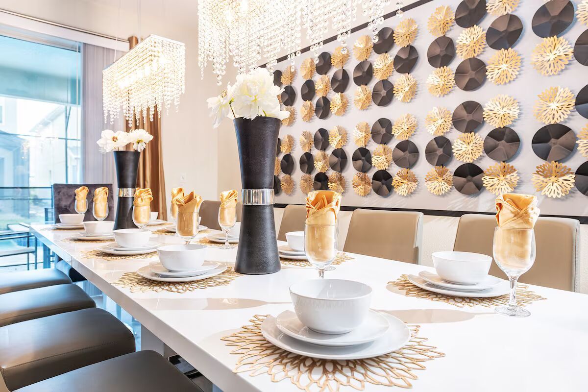 Luxurious dining setup with elegant decor, crystal lighting, and seating for 12.