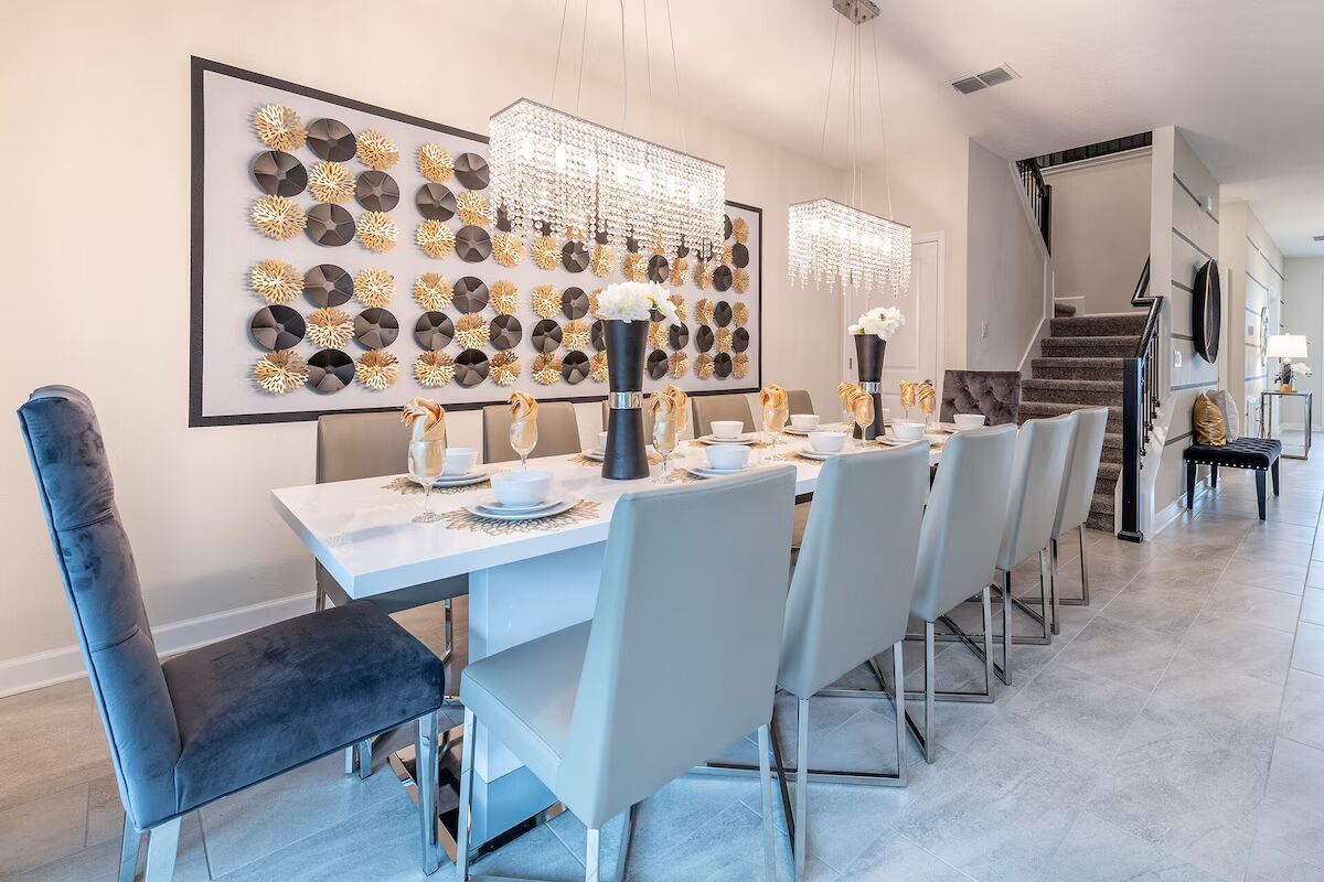 Chic dining area with crystal chandeliers, modern art, and seating for twelve!