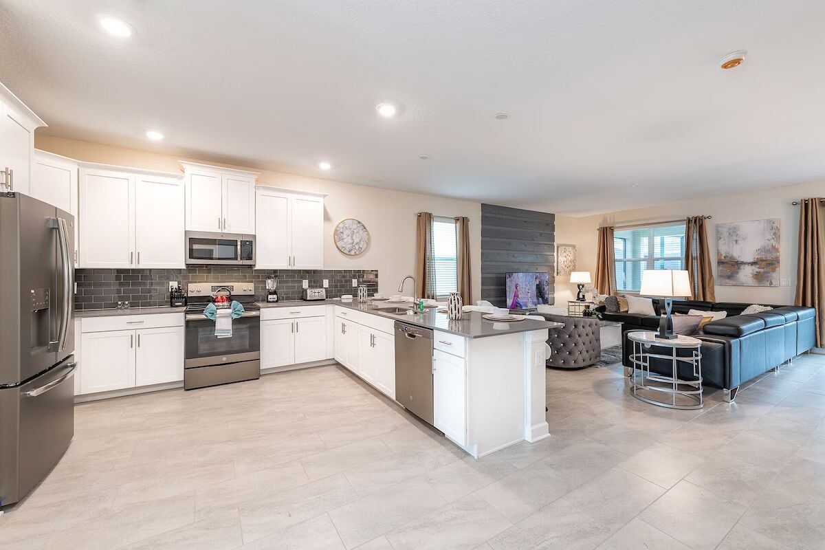 Spacious open kitchen and living area with sleek design and plenty of seating!