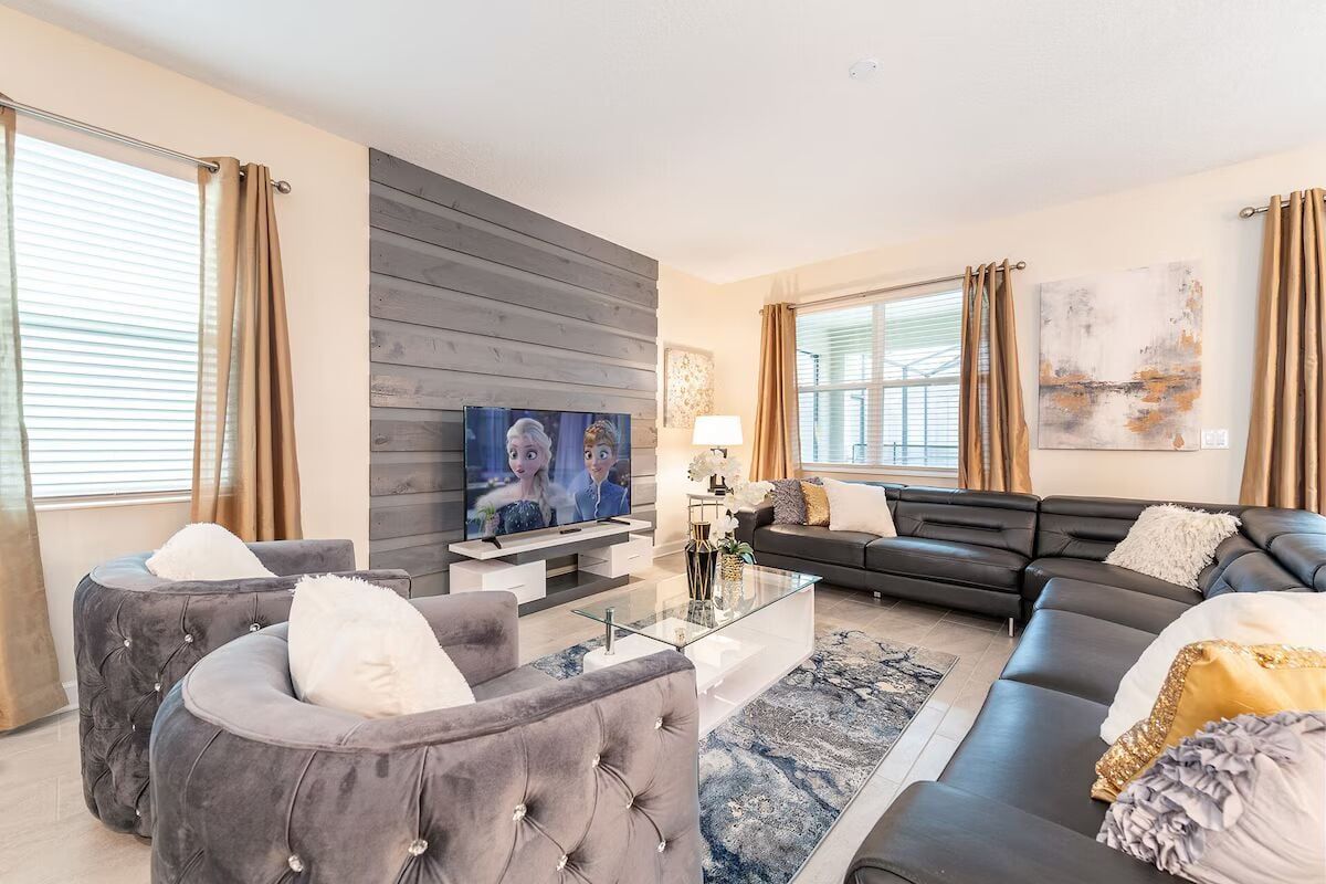 Bright, stylish living room with plush seating, big screen TV, and modern flair!